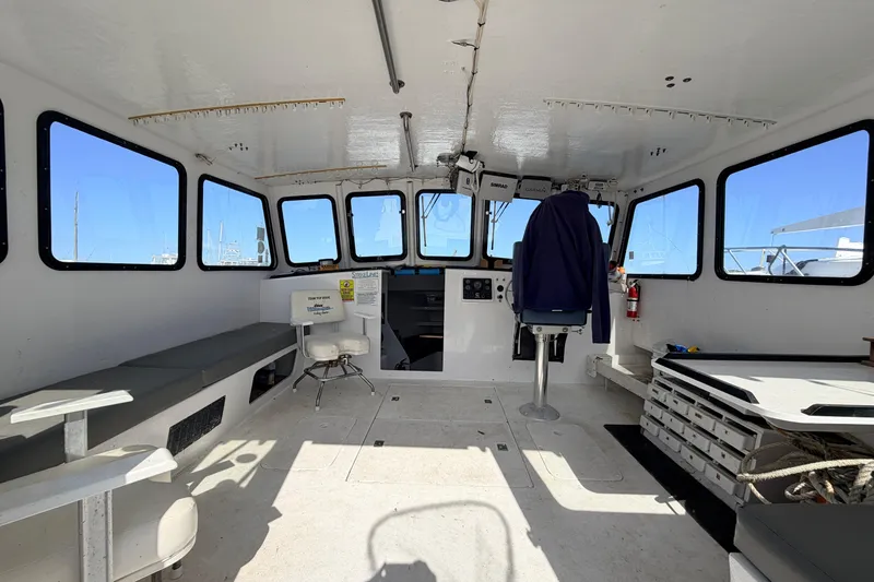 Slide: The Image of Interior of a 1997 H&H Marine 38 boat, featuring seating and navigation equipment. - 2