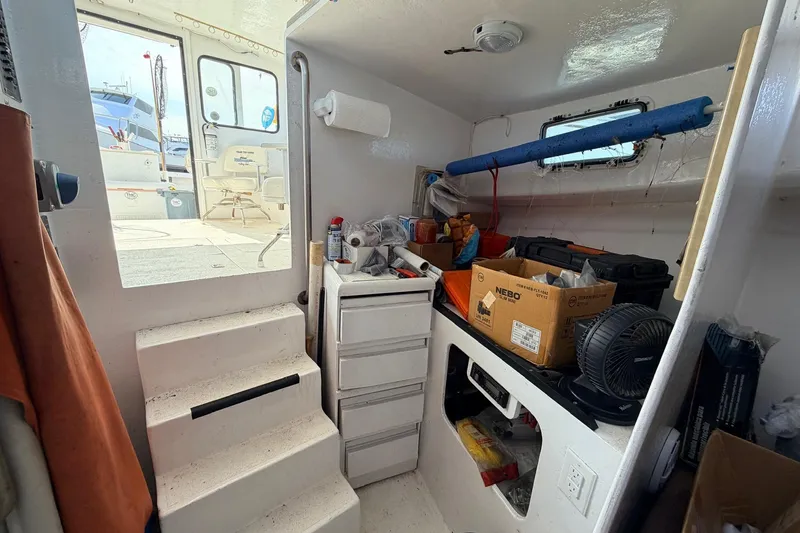 Slide: The Image of Interior of a 1997 H&H Marine 38 boat with storage and equipment. - 24