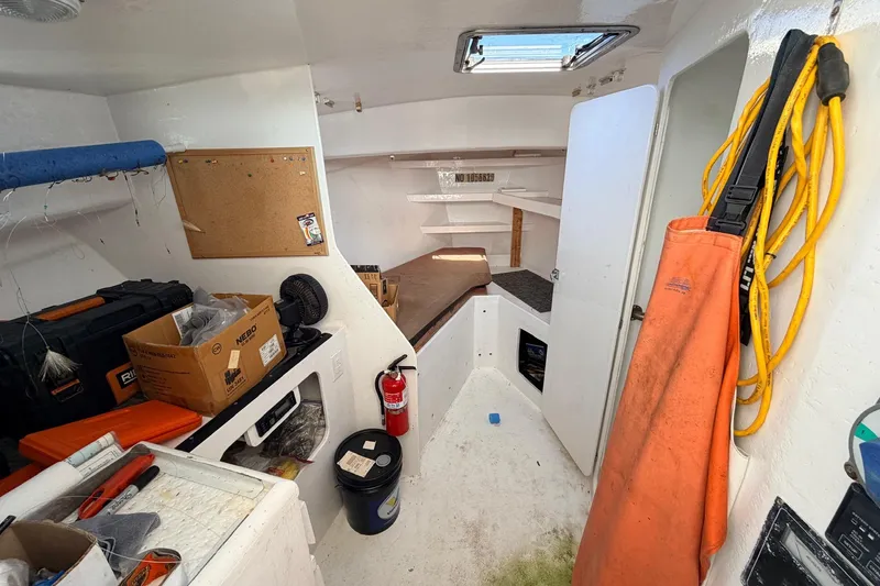 Slide: The Image of Interior of a 1997 H&H Marine 38 boat with tools and equipment. - 25