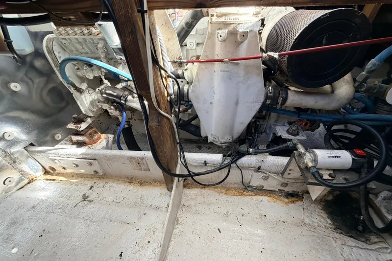 Slide: The Image of Engine compartment of a 1997 H&H Marine 38 boat, showing mechanical components and wiring. - 32