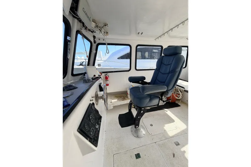 Slide: The Image of Interior of a 1997 H&H Marine 38 boat with captain's chair and navigation equipment. - 36