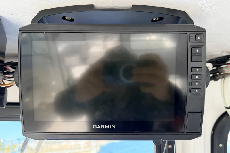 Slide: The Image of Garmin marine GPS device on a 1997 H&H Marine 38 boat dashboard. - 37