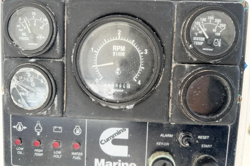 Slide: The Image of Close-up of a 1997 H&H Marine 38 engine control panel with gauges and indicators. - 38