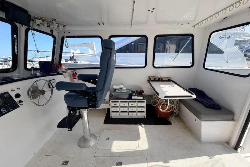 Slide: The Image of Interior of a 1997 H&H Marine 38 boat with helm, seating, and navigation equipment. - 41