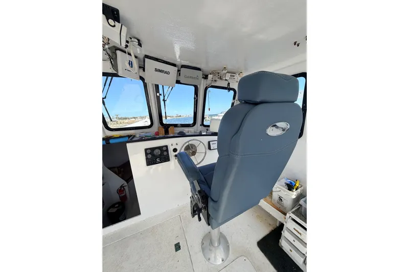 Slide: The Image of Interior of 1997 H&H Marine 38 boat with navigation equipment and captain's chair. - 6