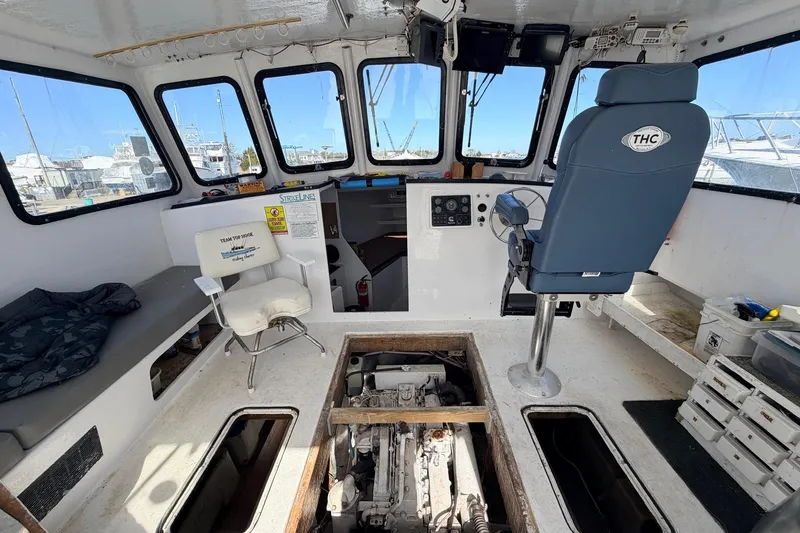 Slide: The Image of 1997 H&H Marine 38 boat interior with helm, seating, and engine access. - 7