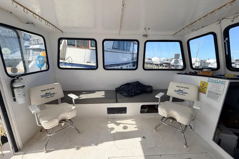 Slide: The Image of Interior of a 1997 H&H Marine 38 boat with seating and windows. - 8