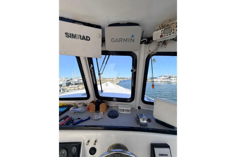 Slide: The Image of Interior view of a 1997 H&H Marine 38 boat with Simrad and Garmin equipment. - 9