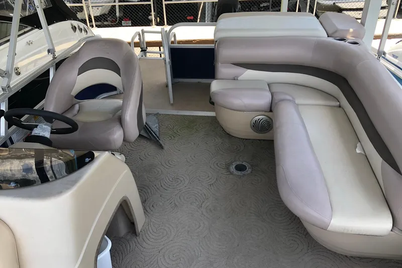 The Image of 2014 Sun Tracker Party Barge 20 DLX interior with seating and steering wheel. - 1