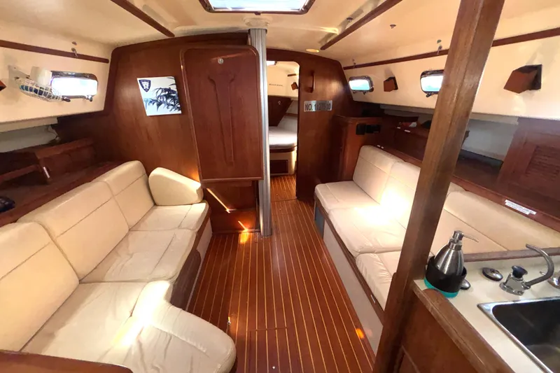 Slide: The Image of Interior of 2002 Island Packet 380 sailboat with cozy seating and wooden finishes. - 14