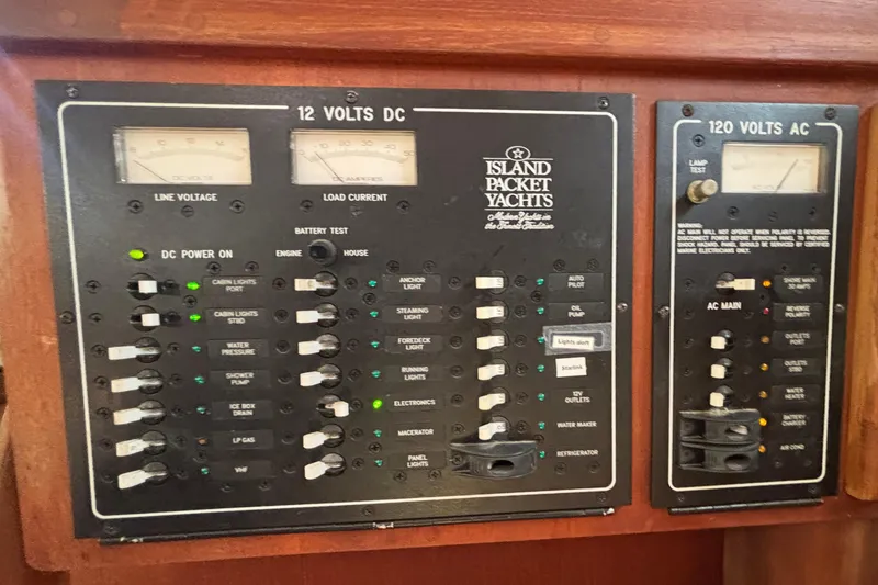 Slide: The Image of Electrical control panel of a 2002 Island Packet 380 yacht, featuring DC and AC systems. - 20
