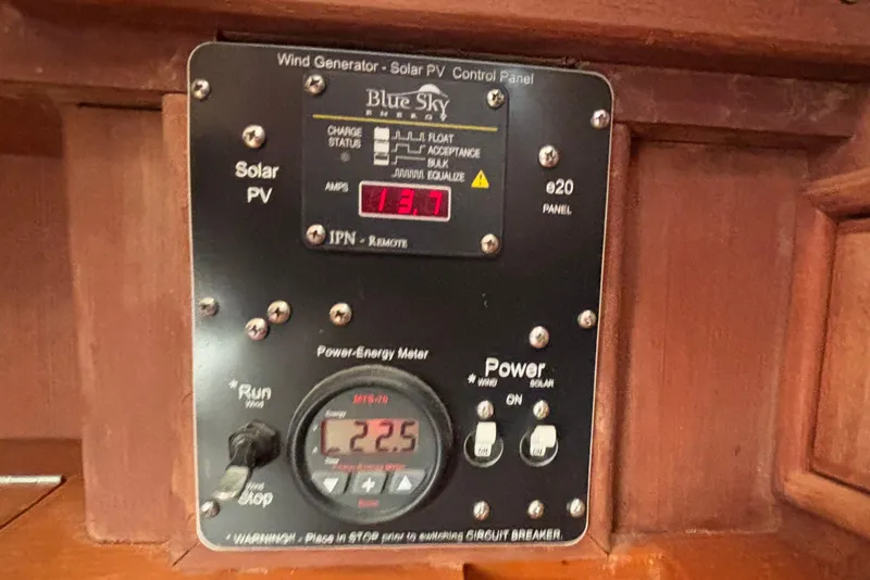 Slide: The Image of Control panel of a 2002 Island Packet 380 sailboat, displaying solar and wind power metrics. - 21
