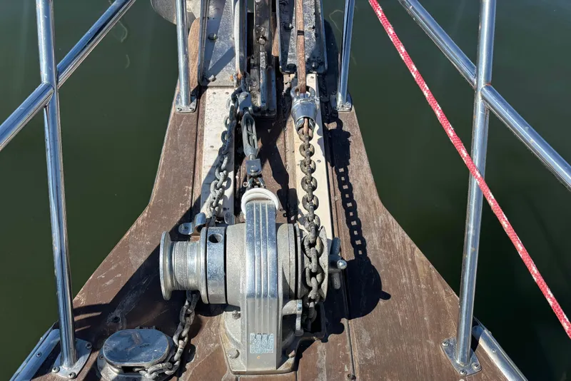 Slide: The Image of Anchor windlass on 2002 Island Packet 380 sailboat deck, with chain and railing. - 26