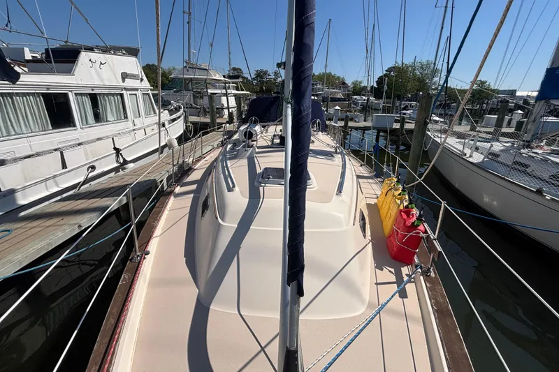 Slide: The Image of 2002 Island Packet 380 sailboat docked at marina, surrounded by other boats. - 28