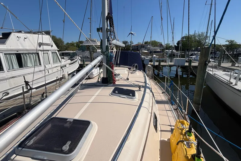 Slide: The Image of Sailboat Island Packet 380, 2002 model, docked at marina with clear blue sky. - 29