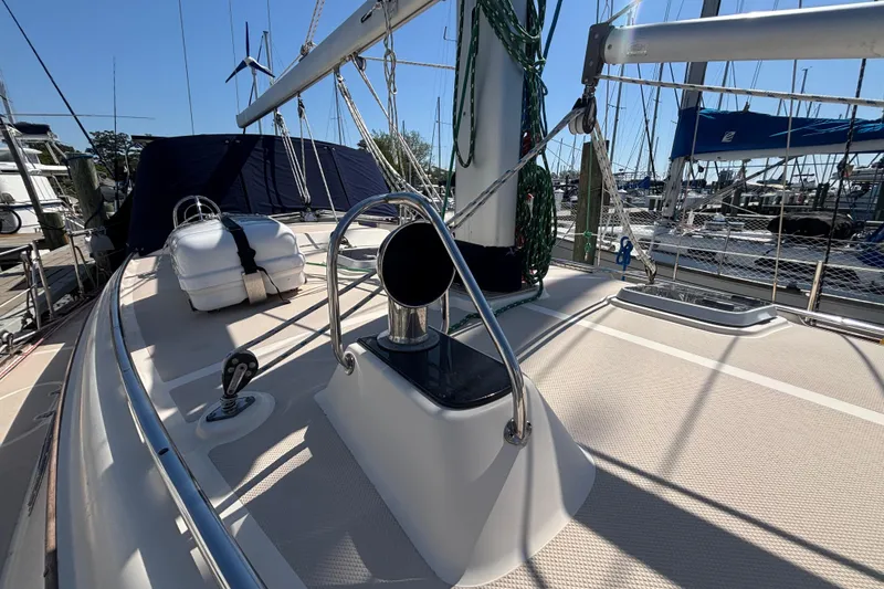 Slide: The Image of 2002 Island Packet 380 sailboat deck with rigging and lifeboat, docked at marina. - 30