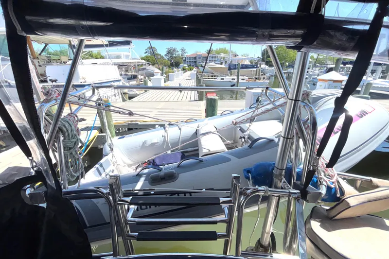 Slide: The Image of Island Packet 380 sailboat docked with inflatable dinghy, 2002 model, marina view. - 31