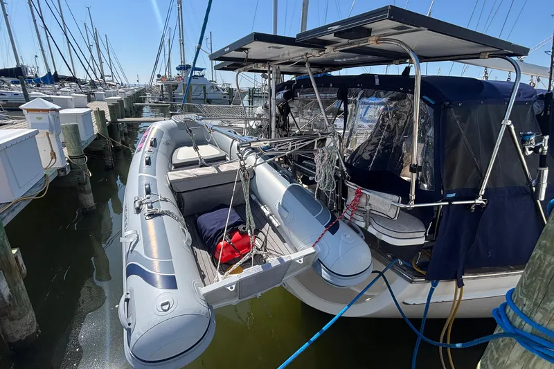 Slide: The Image of Docked 2002 Island Packet 380 sailboat with inflatable dinghy, marina setting. - 32
