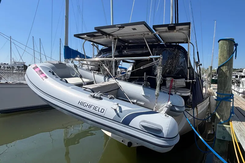 Slide: The Image of Island Packet 380 sailboat with dinghy, docked at marina, 2002 model. - 33
