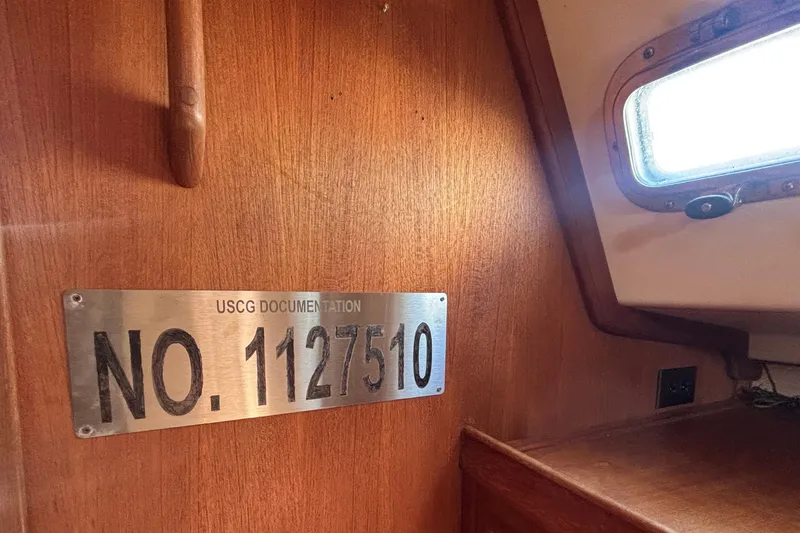 Slide: The Image of USCG documentation plaque on 2002 Island Packet 380 sailboat interior. - 36