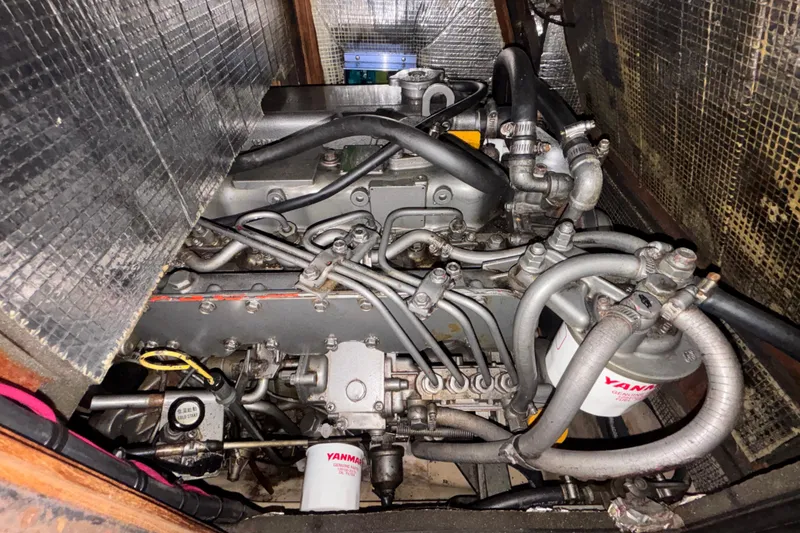 Slide: The Image of Engine compartment of a 2002 Island Packet 380 sailboat, featuring Yanmar components. - 38