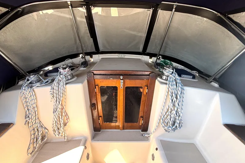 Slide: The Image of Cockpit of 2002 Island Packet 380 sailboat with ropes and wooden hatch. - 40
