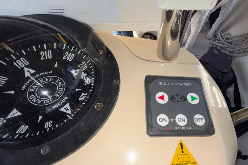 Slide: The Image of Compass and thruster controls on a 2002 Island Packet 380 yacht. - 42