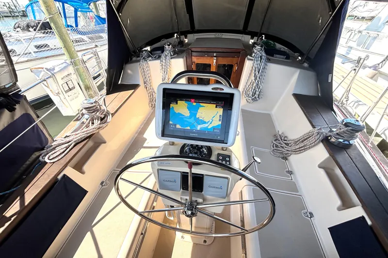 Slide: The Image of Cockpit of 2002 Island Packet 380 sailboat with Garmin navigation system and steering wheel. - 46