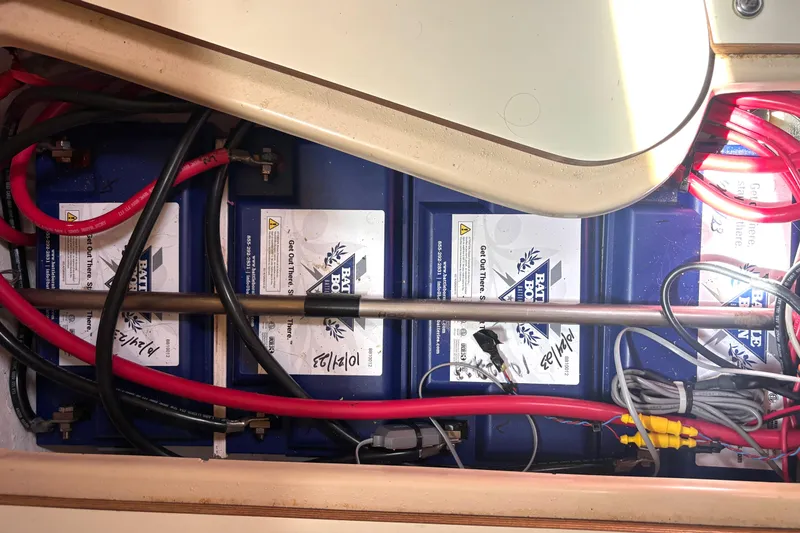Slide: The Image of Battery compartment of a 2002 Island Packet 380 sailboat with wiring and connections. - 49