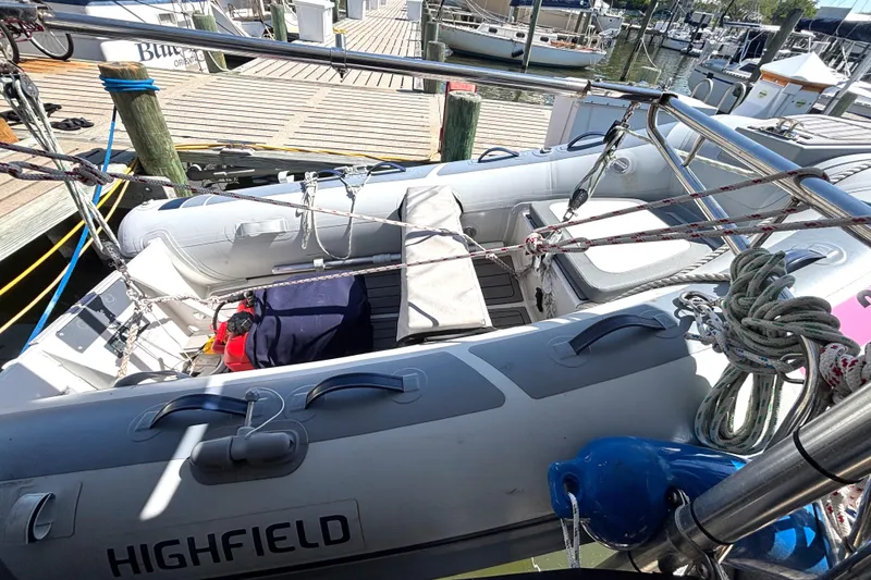 Slide: The Image of Inflatable dinghy on Island Packet 380 sailboat, docked at marina, 2002 model. - 52