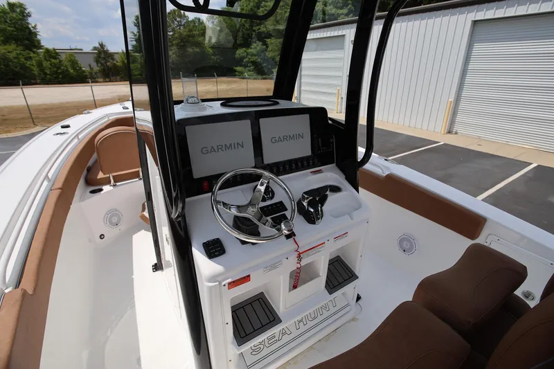Slide: The Image of 2024 Sea Hunt Ultra 275 SE boat cockpit with Garmin displays and steering wheel. - 10