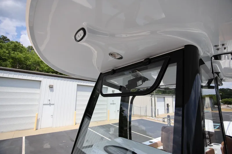 Slide: The Image of 2024 Sea Hunt Ultra 275 SE boat canopy and windshield detail. - 21