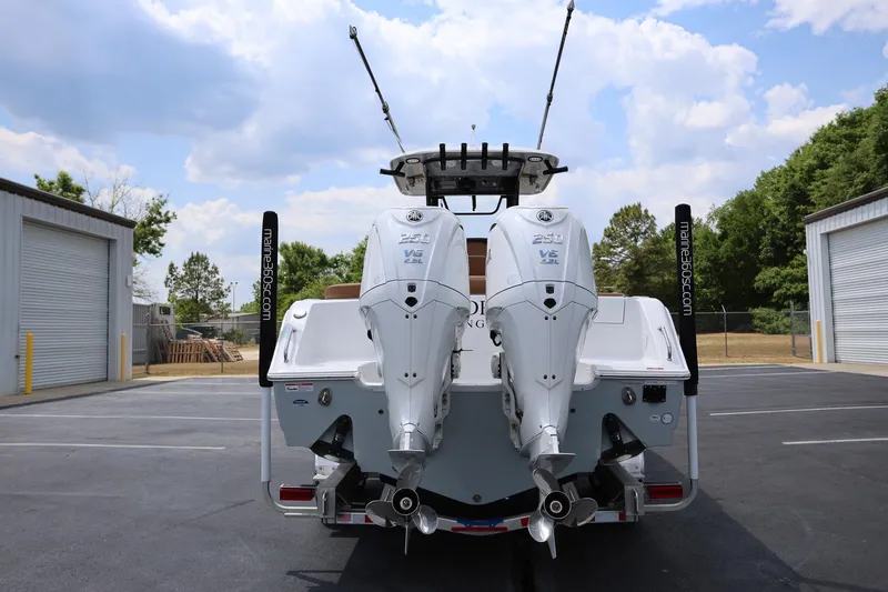 Slide: The Image of 2024 Sea Hunt Ultra 275 SE boat with dual outboard engines in a parking lot. - 3