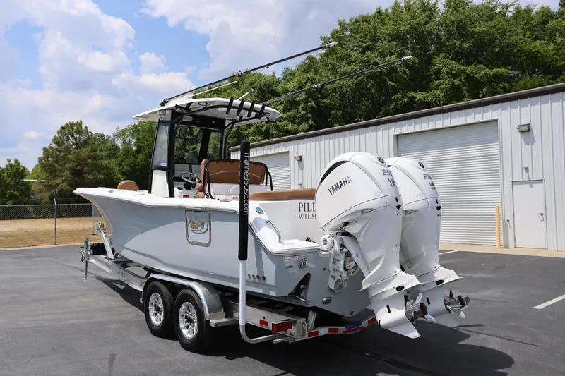 Slide: The Image of 2024 Sea Hunt Ultra 275 SE boat with dual Yamaha engines on a trailer. - 4