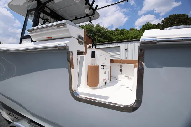 Slide: The Image of 2024 Sea Hunt Ultra 275 SE boat interior with open side door, showcasing sleek design. - 6