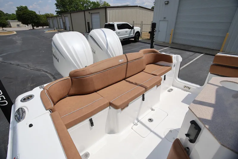 Slide: The Image of 2024 Sea Hunt Ultra 275 SE boat with tan seating and dual Yamaha engines. - 7