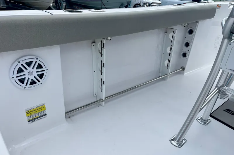 Slide: The Image of 2023 Sportsman Open 232 Center Console interior with speaker and rod holders. - 10