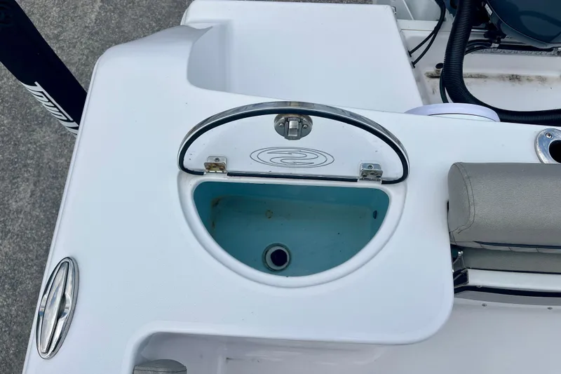 Slide: The Image of 2023 Sportsman Open 232 Center Console boat's livewell with open lid and seating detail. - 11