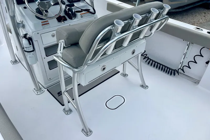 Slide: The Image of 2023 Sportsman Open 232 Center Console boat interior with rod holders and steering console. - 14