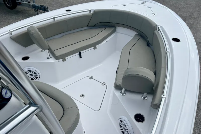 Slide: The Image of 2023 Sportsman Open 232 Center Console boat interior with cushioned seating and storage compartments. - 15