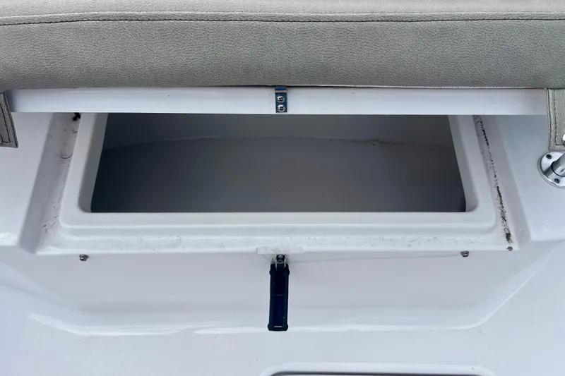 Slide: The Image of Open storage compartment on 2023 Sportsman Open 232 Center Console boat. - 16
