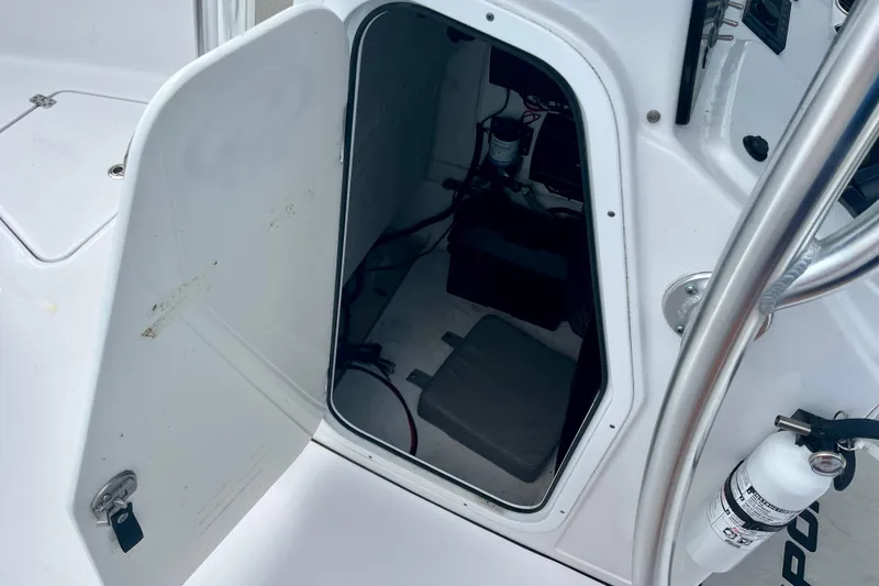 Slide: The Image of Open storage compartment on 2023 Sportsman Open 232 Center Console boat. - 19