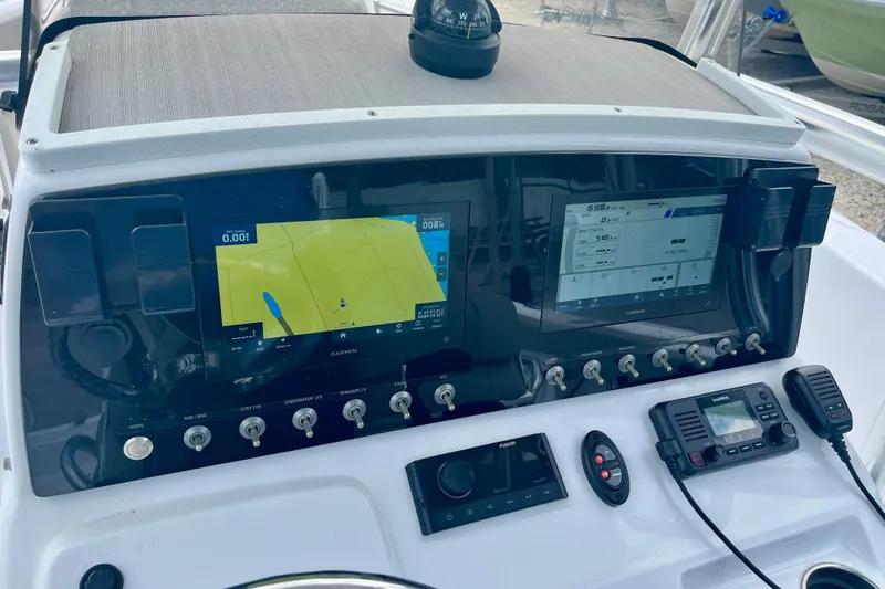 Slide: The Image of 2023 Sportsman Open 232 Center Console dashboard with dual Garmin displays and controls. - 22