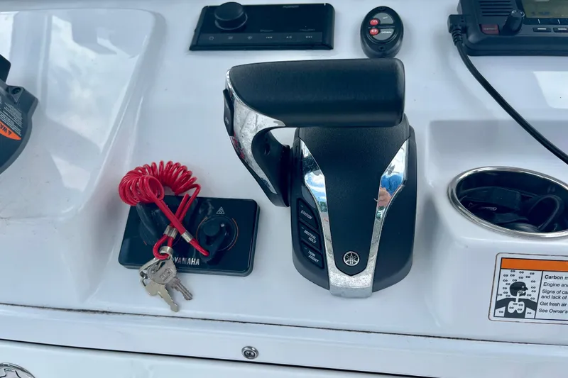 Slide: The Image of Control panel of 2023 Sportsman Open 232 Center Console with Yamaha throttle and keys. - 23