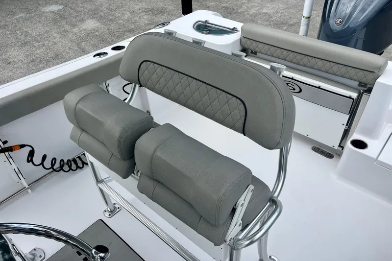 Slide: The Image of 2023 Sportsman Open 232 Center Console boat interior with cushioned seating and sleek design. - 24