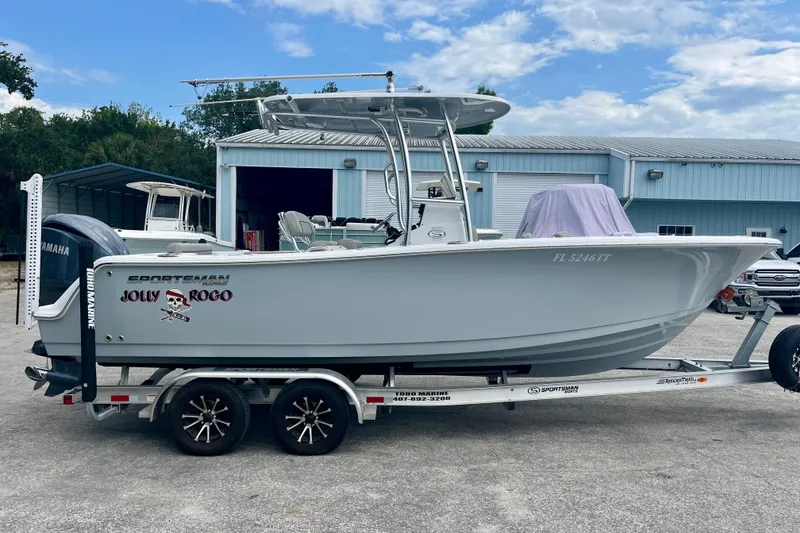 Slide: The Image of 2023 Sportsman Open 232 Center Console boat on trailer, parked outdoors. - 7