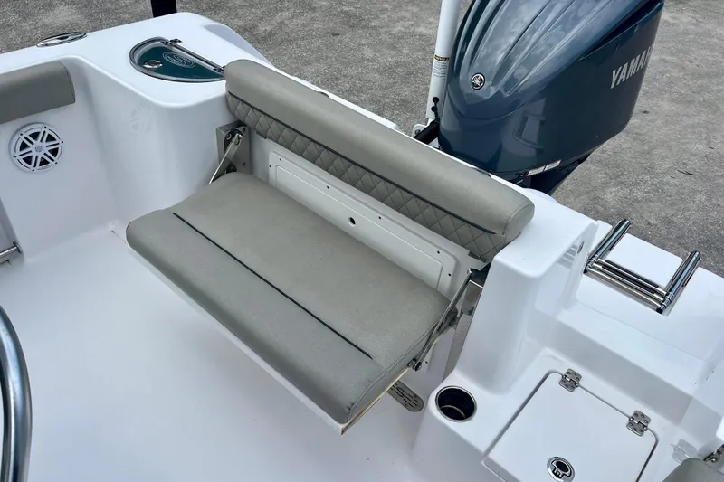 Slide: The Image of 2023 Sportsman Open 232 Center Console boat with cushioned seating and Yamaha engine. - 8