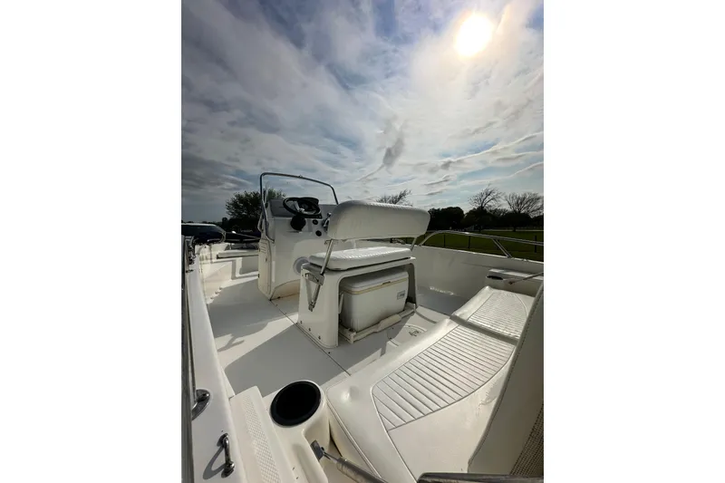 Slide: The Image of 2008 Boston Whaler 180 Dauntless boat interior under a cloudy sky. - 12