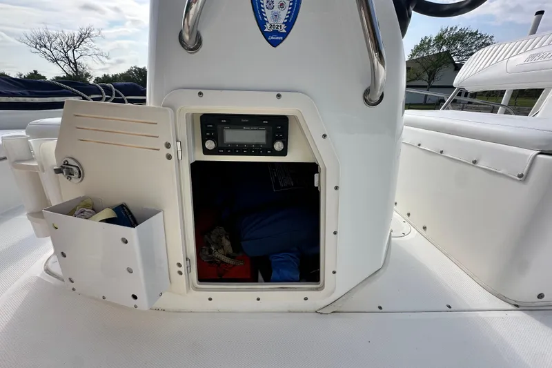 Slide: The Image of 2008 Boston Whaler 180 Dauntless boat console with open storage compartment and stereo system. - 17