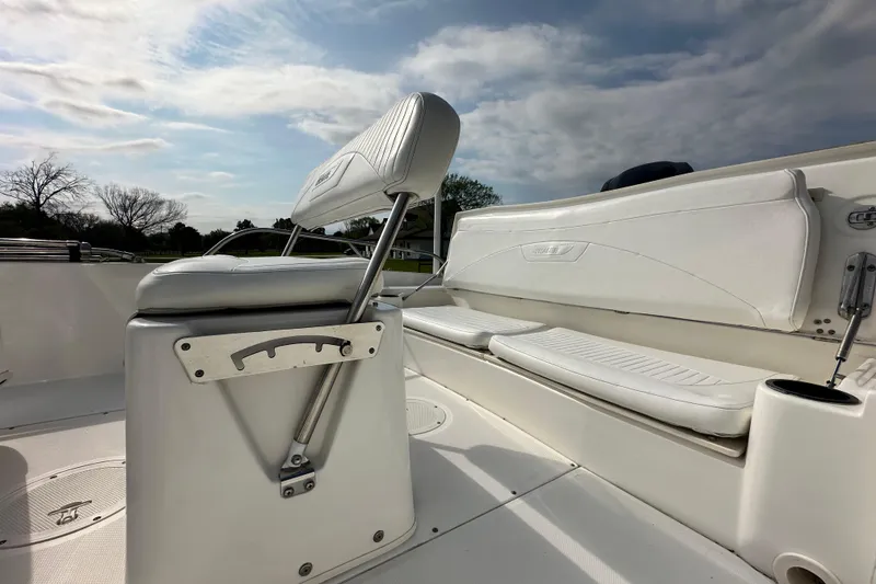 Slide: The Image of 2008 Boston Whaler 180 Dauntless boat interior with white seating and clear sky background. - 19